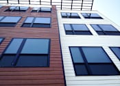 Thumbnail 19 of 36 - Modern exterior facade with horizontal siding and large windows at 68 Beale Apartments, Quincy, MA
